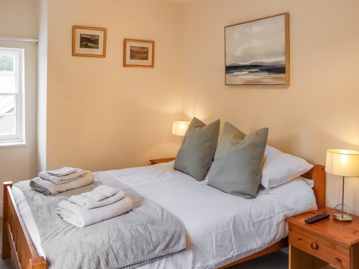 Warm double bedroom with neatly made bed