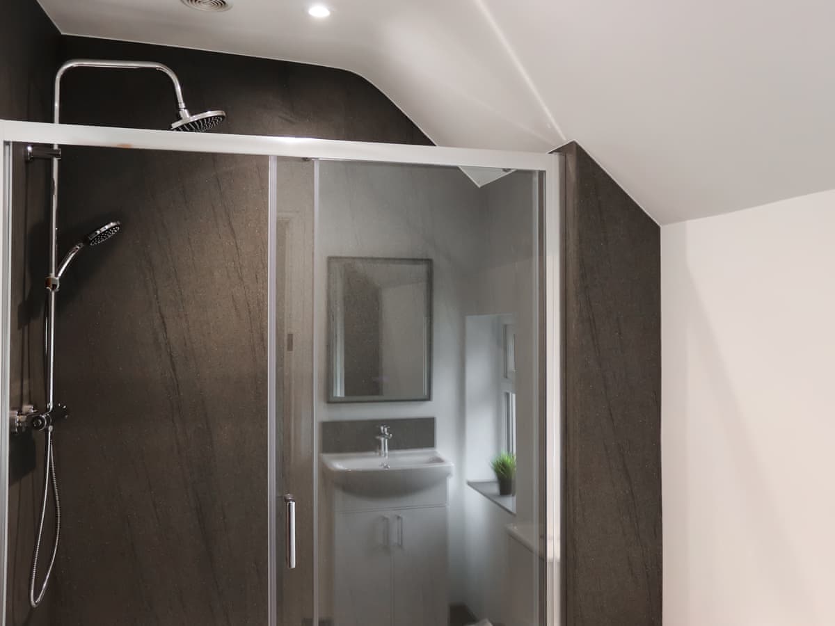 Dark tiled walk-in shower