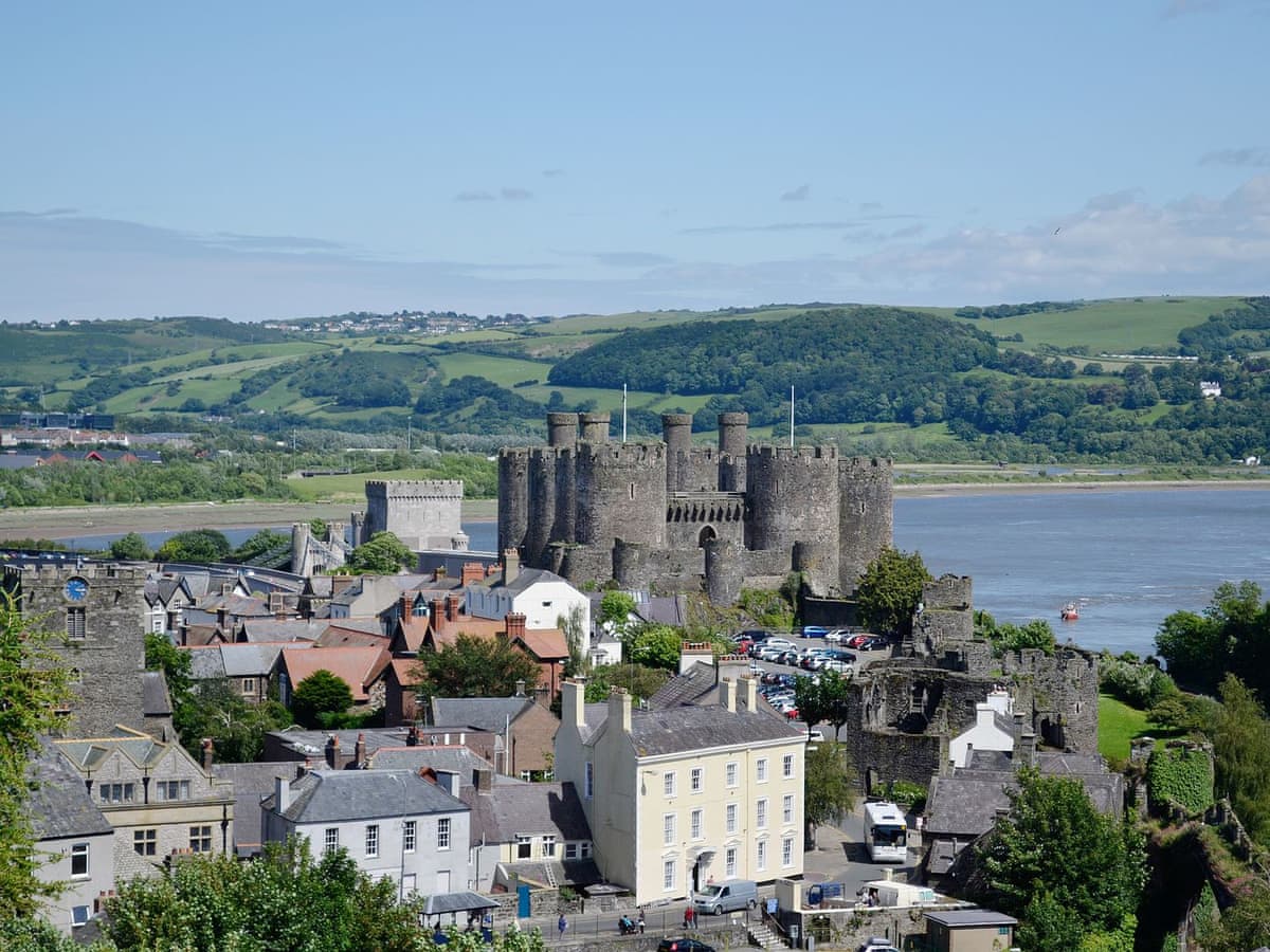 Conwy Castle, town rooftops and green hills